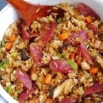 Chinese sausage rice in a saucepan with overlay text that says Chinese sausage rice.
