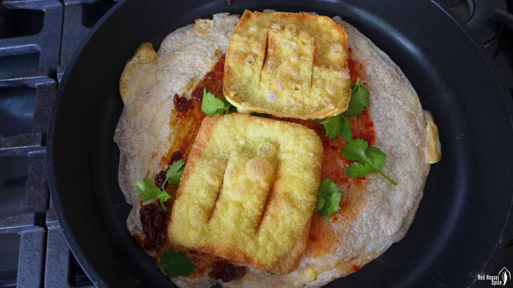 A crepe topped with fried wonton wrappers