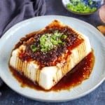 a block of silken tofu with scallion and soy dressing
